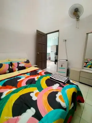 a bedroom with a bed with a colorful comforter at Pa&Ma HomeStay Kulim II 3R2B fully aircond wifi netflix in Kulim