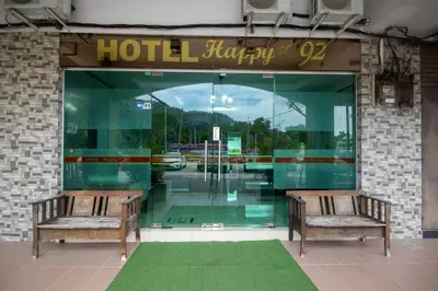 two benches sitting in front of a hotel lobby at JQ Happy Lumut Hotel in Lumut