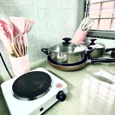 a toaster oven on a counter with a pot and utensils at MayiiVip Homestay - Menglembu in Ipoh