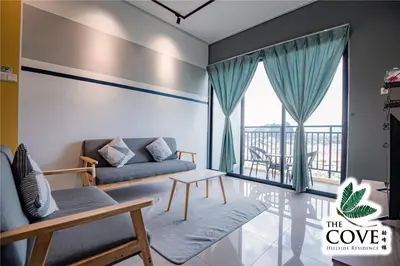 a living room with a couch and a balcony at Ipoh Tambun Waterpark Apartment The Cove Hillside in Ipoh