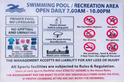 a sign that reads swimming pool recreation area open daily at Ipoh Tambun Waterpark Apartment The Cove Hillside in Ipoh
