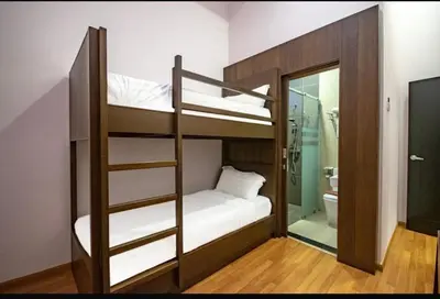 a bunk bed in a room with a bathroom at 16celsius at Kea Farm Brinchang in Brinchang