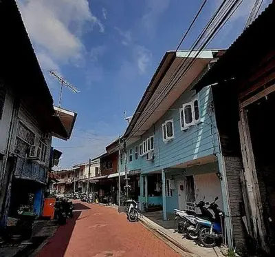 a city street with houses and a blue building at 5 Lot 10 Pangkor Leisure Beach Studio in Pangkor