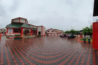 a brick parking lot with a building in the rain at 39 Lot 10 Pangkor Leisure Beach Studio in Pangkor