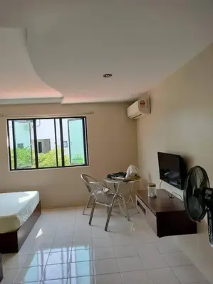a room with a bed and a table and a television at 39 Lot 10 Pangkor Leisure Beach Studio in Pangkor