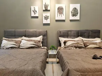 two beds in a bedroom with pictures on the wall at 20-24Paxx Near Sunway Lst World wPool Tab Karaok in Ipoh