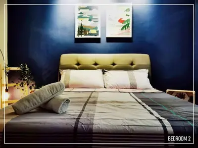 a bedroom with a bed with a blue wall at 11pax5br Modern 5mins Ipoh Town wPoolTable in Ipoh