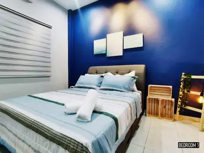 a blue bedroom with a large bed with blue walls at 11pax5br Modern 5mins Ipoh Town wPoolTable in Ipoh