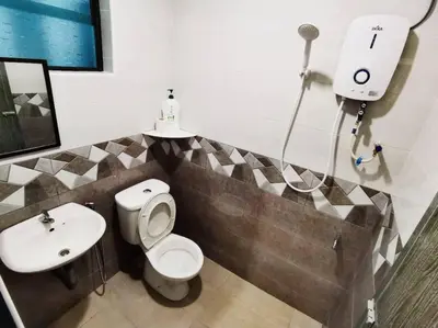a bathroom with a toilet and a sink at 11pax5br Modern 5mins Ipoh Town wPoolTable in Ipoh
