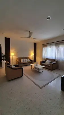 a large living room with couches and a table at Cozy House in Taiping in Taiping