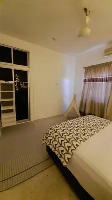 a bedroom with a bed and a window at Cozy House in Taiping in Taiping