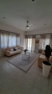 a large living room with two couches and a table at Cozy House in Taiping in Taiping