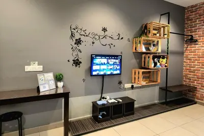 a room with a tv on a wall at Ipoh City Centre 八角楼 OCTAGON Homestay - 2 mins walking to famous food & 15 mins to Old Town Ipoh by Happy Homestay in Ipoh