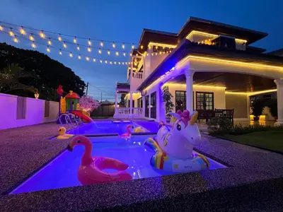 a swimming pool with two rubber ducks in a backyard at C&C Villa Pool Ipoh in Ipoh
