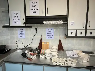 a kitchen with a counter top with plates and bowls at C&C Villa Pool Ipoh in Ipoh