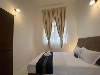 a bedroom with a large bed with a window at C&C Villa Pool Ipoh in Ipoh