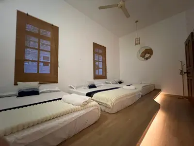 a room with three beds in it at C&C Villa Pool Ipoh in Ipoh
