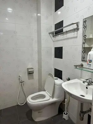 a bathroom with a toilet and a sink at Double Storey House at Raja Uda with 3 rooms in Butterworth