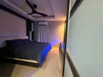 a bedroom with a bed and a ceiling fan at Double Storey House at Raja Uda with 3 rooms in Butterworth