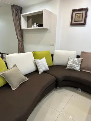 a couch with pillows on it in a living room at Double Storey House at Raja Uda with 3 rooms in Butterworth