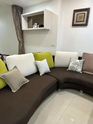 a couch with pillows on it in a living room at Double Storey House at Raja Uda with 3 rooms in Butterworth