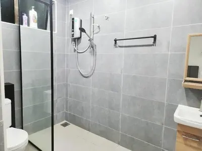 a shower stall in a bathroom with a toilet at IPOH MENGLEMBU LOHAS 4BR3Bath14 PAX in Ipoh