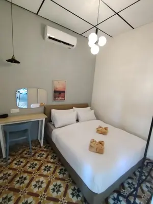 a small room with a bed and a desk at Georgetown Guest House 37 in George Town