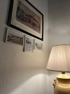 a room with a lamp and pictures on a wall at The Gaslight Heritage Residence - NEW in George Town