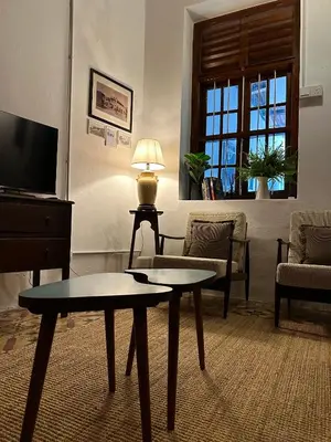 a living room with a coffee table and a tv at The Gaslight Heritage Residence - NEW in George Town