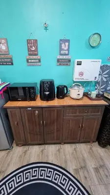 a wooden counter in a room with a counter top at MAR Homestay Seri Iskandar in Seri Iskandar