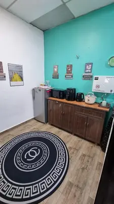 a room with a kitchen with a large rug on the floor at MAR Homestay Seri Iskandar in Seri Iskandar