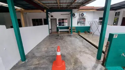 an orange traffic cone in front of a building at MAR Homestay Seri Iskandar in Seri Iskandar