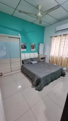 a bedroom with a bed in a room with blue walls at MAR Homestay Seri Iskandar in Seri Iskandar