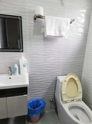 a bathroom with a white toilet and a sink at 10Min to IPOH TOWN 4BR20PAX MAHJONG GAME KARAOK in Ipoh