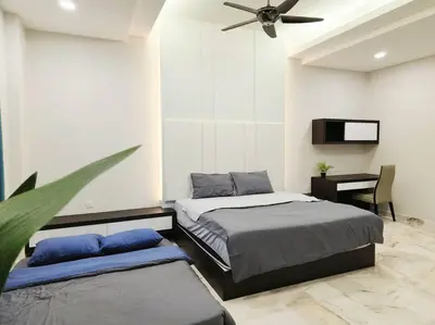a bedroom with two beds and a ceiling fan at 10Min to IPOH TOWN 4BR20PAX MAHJONG GAME KARAOK in Ipoh