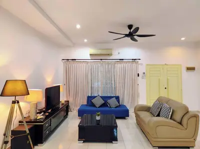 a living room with a blue couch and a tv at 10min to IPOH town GEMILANG TAWAS 4br4bath 14pax in Ipoh