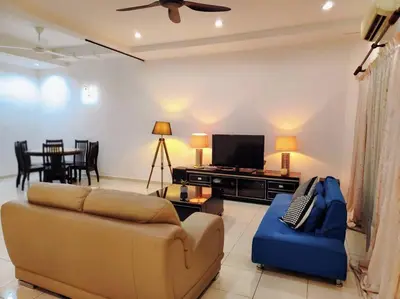 a living room with a couch and a tv at 10min to IPOH town GEMILANG TAWAS 4br4bath 14pax in Ipoh