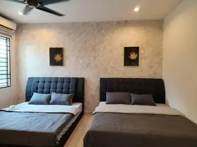 two beds sitting next to each other in a bedroom at 10min to IPOH town GEMILANG TAWAS 4br4bath 14pax in Ipoh
