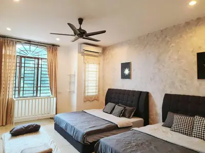a bedroom with two beds and a ceiling fan at 10min to IPOH town GEMILANG TAWAS 4br4bath 14pax in Ipoh