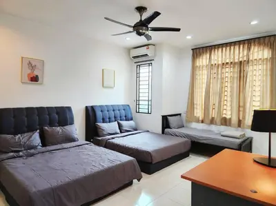 a bedroom with two beds and a couch at 10min to IPOH TOWN gunung lang 4br4bath 14 pax in Ipoh