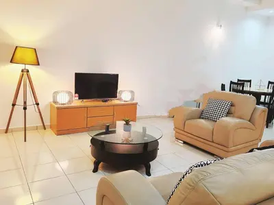 a living room with two couches and a television at 10min to IPOH TOWN gunung lang 4br4bath 14 pax in Ipoh
