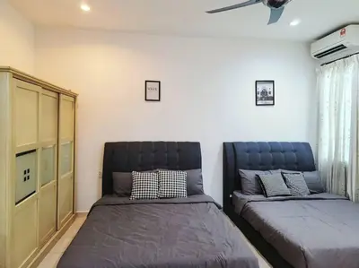 a bedroom with two beds and a ceiling fan at 10min to IPOH TOWN gunung lang 4br4bath 14 pax in Ipoh