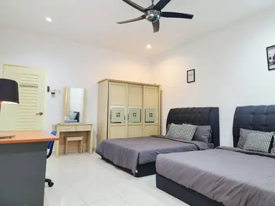 a bedroom with two beds and a ceiling fan at 10min to IPOH TOWN gunung lang 4br4bath 14 pax in Ipoh