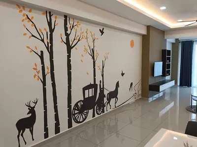 a room with a wall mural of trees and a man in a wheelchair at Happy Homestay TheVenus Sitiawan in Sitiawan
