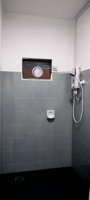 a bathroom with a shower stall with a window at 23 Inn Singlebed Share Bathroom No Window in Bukit Mertajam