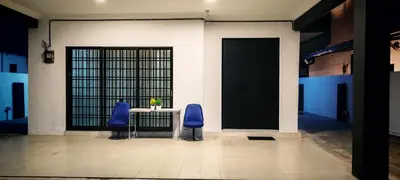 two blue chairs sitting at a table in a building at 23 Inn Singlebed Share Bathroom No Window in Bukit Mertajam