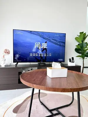 a living room with a tv and a wooden table at URBAN Georgetown 9Pax 4QueenBed 3Bedroom 2Bath 2carparks in Jelutong