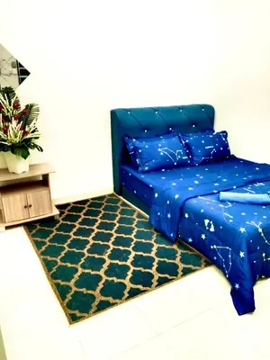 a bedroom with a blue bed and a rug at Homestay Arora Teluk Intan in Teluk Intan