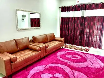 a living room with a couch and a pink rug at Homestay Arora Teluk Intan in Teluk Intan