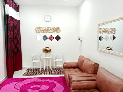 a living room with a couch and a table at Homestay Arora Teluk Intan in Teluk Intan